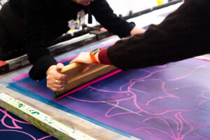 Close up of people learning to screen print