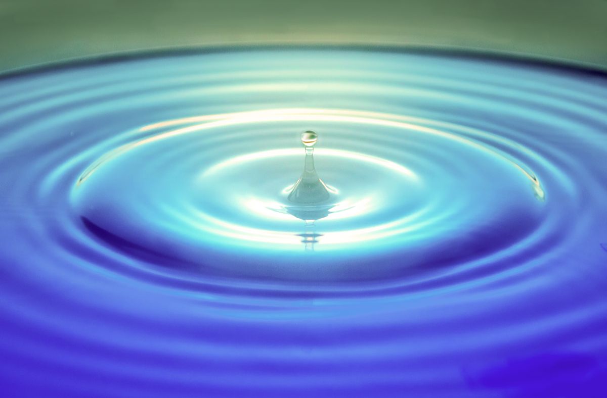 A drop of water causing a ripple effect