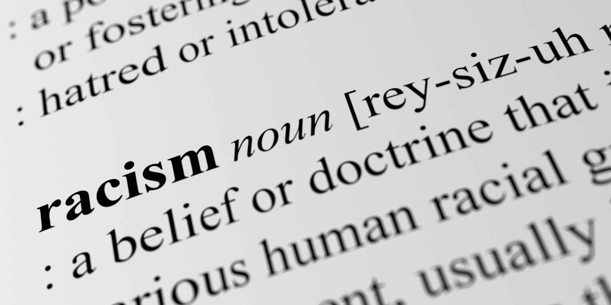 Close-up of a dictionary definition of the word “racism”.